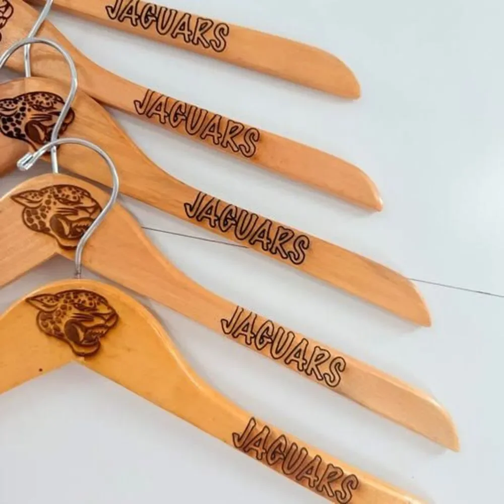5 custom wood hangers with Jacksonville Jaguars branding.